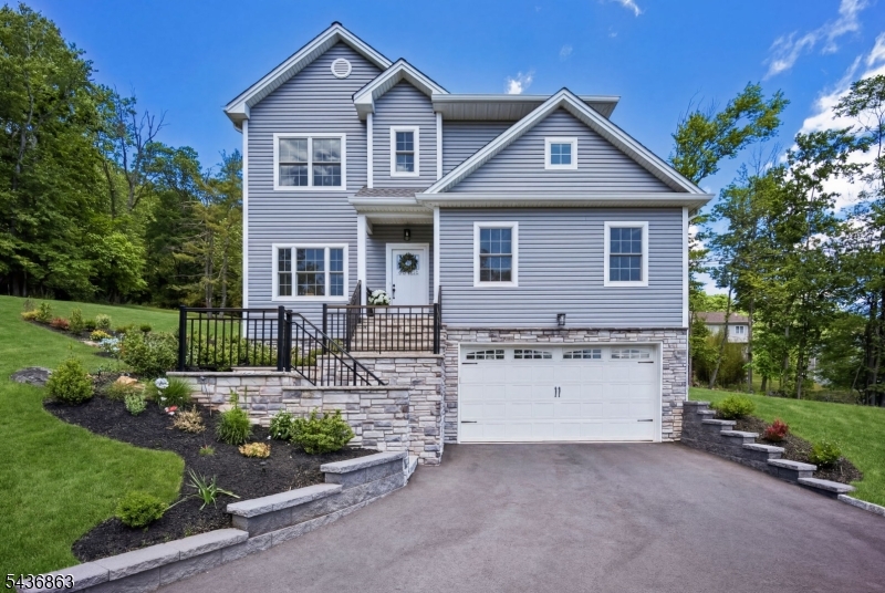 RARE NEW 2025 BUILD complete with BUILDERS WARRANTY and Upgrades by Current Owner. 6BR/4.5Baths, Approx. 4400 Finished SF (inc. Basement). White Oak HW Floors on 1st/2nd floors. Private 1.06 acre double lot with walking trails to Washington Rock State Park. The quiet elevation offers sweeping views.  The home opens to a bright family room with access to a wrap-around paver patio for outdoor/indoor living. A Chef's kitchen with "miles" of quartz counter space also boasts a walk-in pantry and large prep island that seats 4.  There is open flow to a family room with fireplace and a large dining room with elaborate moldings. The first floor has a guest suite w/full bath and walk-in closet. Upstairs, the Primary Suite has a large custom walk-in closet, bath w/dual vanities, large shower stall and soaking tub.  Three additional BR's, Full Bath and Laundry room complete this floor. The Finished Basement has an office w/closet storage, Full Bath and Recreation room. Storage galore in this home. The Seller's post build work includes: A wrap-around paver patio, exterior French drains, dedicated trampoline area, finished garage with epoxy floors and new Appliances throughout. EV pre-wired 2 car garage, Watchung Hills High School, 8 minutes to Dunellen Train Station.  MOVE-IN READY, EVERY UPGRADE COMPLETE.