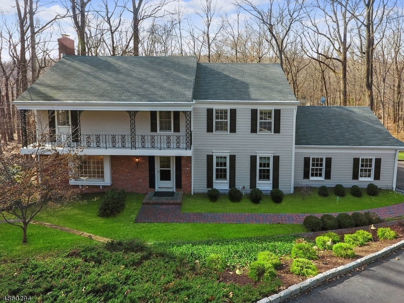 Fabulous 4 bedroom, 2 full, 2 half bath Kaplan-built colonial on quiet, secluded cul-de-sac just minuets from Morristown Green.  Gorgeous, light-filled front to back living room with hardwood floors adjoints the formal dining room with chair & crown moldings, updated kitchen with granite countertops & center island, family room with built-ins, laundry room & powder room complete the first floor.  Second floor features a spacious master bedroom suite with walk-in closet, dressing area & updated bath, 3 additional bedrooms all with hardwood floors & updated main bath.  The lower level offers a fantastic rec room, workshop, storage, wet bar, powder room & sliders to a patio.  Property backs to park land.  New composite siding.  Minutes from Mid-town Direct NYC train, highly desirable neighborhood.