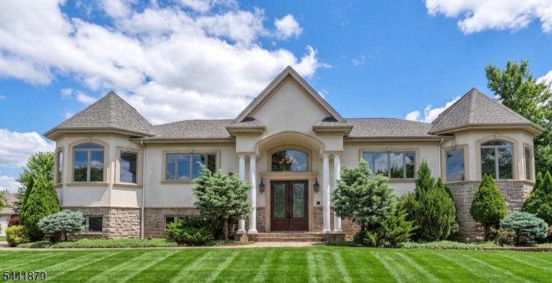 Built in 2011 and ideally located in the heart of Englewood Cliffs, this custom home offers impressive curb appeal and a thoughtfully designed floor plan. A graceful winding staircase welcomes you into the grand entry foyer, where soaring ceilings and a floor-to-ceiling stone fireplace create a stunning focal point in the great room. The open-concept layout flows seamlessly into the spacious eat-in kitchen with direct access to the covered Trex deck, making it ideal for everyday living and entertaining. A butler?s pantry connects the kitchen to the formal dining room and leads to a versatile bonus space, perfect as a home office, formal living room, or sitting area. The primary bedroom offers a spacious retreat with a luxurious bath featuring a jetted tub and double vanity. Two additional bedrooms, a full hall bath, and a powder room complete the main level. The finished lower level expands the living space with a large family room, second gas fireplace, two additional bedrooms, a full bathroom, a laundry room, and a mudroom with access to the three-car garage. Direct walkout access adds convenience and flexibility to this level. Located near top-rated schools, parks, major highways, shopping, dining, and NYC transportation, this exceptional home offers the perfect blend of comfort, convenience, and style.