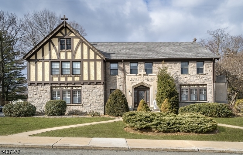 A truly rare opportunity awaits with this former rectory, offering an extraordinary combination of space, character, and endless possibilities. Rich in history & filled with architectural charm, this one-of-a-kind property provides an impressive layout designed to accommodate a variety of uses. The first floor welcomes you with a gracious entry foyer leading to expansive living and dining room, a large eat in kitchen complete with an oversized pantry, two bedrooms, a full bath, and a spacious family room. Adding to the home's unique appeal is a private chapel, preserving the property's distinctive heritage & creating a remarkable space unlike anything else on the market. The second floor offers exceptional living quarters: five generously sized bedroom suites, each with its own attached sitting area. For those seeking additional sleeping accommodations, the existing layout presents the potential to create up to ten bedrooms by enclosing the sitting areas. Three full bathrooms serve this level. On the third floor you'll find a large unfinished attic with so much potential for storage, expansion, or finishing. The lower level is equally impressive, featuring 8 foot ceilings, a large open recreation room, a summer kitchen, laundry area, and numerous storage rooms. Whether you're seeking a spacious private residence, institutional use, or a property with redevelopment potential, this remarkable property offers unmatched size, flexibility, & opportunity.