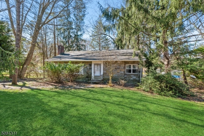 Cozy stone Ranch w/2 BRs, 1 BA & detached 2-car garage on a private, large green lot in No. Summit. Enjoy Summit's beautiful downtown, mins to local schools, shops, restaurants, hwys & NYC NJ Transit. A sweeping front lawn invites you to a foyer opening to a sunny living rm w/ a brick FP. Entertain in the DR & eat-in kitchen w/access to the deep, fenced-in backyard. Relax in the screened in-porch off the DR. 1st FL feats 2 sunny BRs, a full BA & ample closets. The walkout LL feats 2 separate entertainment/office/game areas w/ a large bar for you & your guests to enjoy.The unfinished attic offers potential for customizing more living space & extra storage.This home is conveniently located to all the add'l amenities Summit has to offer, including coffee shops, several beautiful parks & Overlook Medical Center.