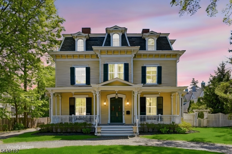 A rare opportunity to own one of Morristown's most iconic and well-maintained Victorian residences, ideally located just moments from downtown restaurants, shopping, NJ Transit direct trains to NYC, parks, schools, and major highways. Set on a beautifully landscaped half-acre lot, this remarkable 1862 Victorian blends timeless character with thoughtful updates designed to preserve the architectural integrity of the home. Historic details include soaring 12-foot ceilings, hardwood floors, intricate millwork, crown moldings, five fireplaces, and expansive living spaces throughout. The gourmet kitchen features custom cabinetry, granite countertops, premium appliances, a walk-in pantry, and breakfast area open to the gathering room. The main level also offers multiple entertaining spaces, a private office with built-ins and fireplace, powder room, and laundry room. The finished lower level includes recreation space, exercise area, cedar closet, half bath, and storage. The second floor features a luxurious primary suite with two additional bedrooms connected by a Jack-and-Jill bath. The third floor offers four additional bedrooms, a full bath, utility room, and abundant storage. A renovated suite above the detached garage provides exceptional flexibility for guest quarters, extended stays, private office, creative studio, or potential professional use. Outdoors, enjoy a private fenced yard, patio, and mature landscaping in the heart of Morristown.