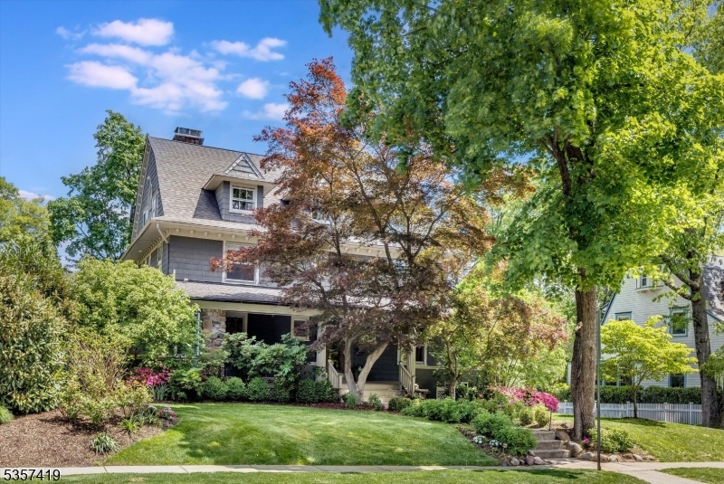 This exquisite Erwin Park Craftsman Colonial has gorgeous period architecture that blends seamlessly with modern updates & unique custom finishes. Step inside from the expansive front porch and you'll find details like period moldings, leaded glass, window seats & pocket doors throughout. Off the foyer is the library/den adorned w/intricate built-in shelves. The generous LR w/ beamed ceilings, woodburning fireplace & French doors leads to a sunny office, perfect for work-from-home w/separate sitting area, powder rm and direct entrance off of the front porch. The spacious DR flows into the beautifully designed chef's kitchen featuring high-end custom wood cabinetry, stunning quartzite counters, wolf range, 2 ovens, sub-zero fridge & separate eating area. Off the kitchen is a skylit sunroom w/ doors that open to the enchanting & private fully fenced yard w/ lushly planted gardens, stone patio and a veggie garden. Second floor boasts an elegant primary suite w/gorgeous ensuite bath, 3 additional bedrooms, a renovated hall bath & tons of closets. The full 3rd floor has 2 more bedrooms, a full bath & grand family room. Outside, you'll find a lovely cobblestone driveway & spectacular stone-walled gardens leading to a charming garage w/ EV charger wiring. Close to Edgemont Pk, MHS, MKA, Watchung Plaza shops, eateries & NYC transportation. A true Montclair gem meticulously maintained w/ many improvements!