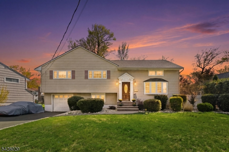 Welcome to this beautiful 4-bedroom, 2.1-bath split-level home nestled on a quiet street in the highly sought-after town of Cranford, NJ. This beautiful home offers spacious, turn-key living across multiple levels.  The open-concept main floor features gleaming floors with a seamless flow from the spacious living room, through the updated kitchen with stainless steel appliances, granite countertops, a breakfast bar, and cherry cabinets, into the dining area where sliders open to the backyard deck, ideal for outdoor gatherings and al fresco dining, in a fully fenced-in yard with mature landscaping.  The second level includes the primary suite with a full bath, 2 additional bedrooms, and a hall bath.  The third level offers a generously sized fourth bedroom with a flexible layout, ideal for guests, a home office, or playroom.  The ground level includes a bright family room, powder room,  laundry/utility room, and access to the attached oversized one-car garage.  Loaded with modern amenities, additional features include bamboo floors, central air, thermal-pane windows, and a fenced-in backyard.Located just minutes from Cranford's top-rated downtown shopping, dining, parks, schools, and NYC bus/train transportation.  This wonderful home checks every box for location, comfort, and convenience.  Come make this yours and seize the opportunity to become part of one of NJ's most desirable communities.