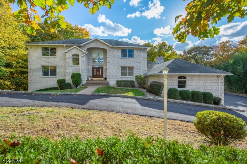 Nestled on an enchanting 2+ acre property in Raine Tree Estates, this sprawling  contemporary colonial offers privacy and breathtaking views. From the soaring two story entrance open to the elegant formal DR and spectacular GR featuring a wall of floor to ceiling windows w/sliders to an expansive deck, the natural and peaceful setting will capture your heart! Sip coffee in the sunny Kitchen w/center island and Breakfast Room open to the inviting FM w/gas fireplace and sliders to the deck. Powder Room, Laundry and access to the garage are located off this wing while an expansive 1st floor BR w/a crisp hall bath w/tub/shower plus an adjacent office could easily be a private guest area.  Ascend the stunning stairwell to the open bridge leading to expansive 2nd level. Primary suite features 9 ft. tray ceiling, hardwood floors & luxurious bath w/skylight, double vanity & tiled shower w/glass door. 3 additional expansive bedrooms w/hardwood floors and ample closets share a large hall bath w/double vanity and tiled shower/tub. An incredible, full finished walkout lower level,  allows for fabulous additional living space! Boasting a spectacular recreation room, well-equipped full kitchen w/marble hearth. A full bathroom allows for a flexible floor plan. Sliders open to the tranquil property & invite one outside to commune w/nature! A three oversized garage allows for ample storage.  A special oasis w/ room for everyone on the most enchanting, bucolic property! Built for entertaining