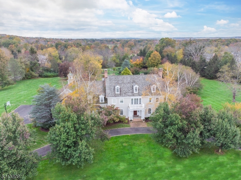 FIRST TIME EVER ON MARKET! This stunning Harding Twp estate home, designed and built by Walter Pfeiffer and Peter Dorne, is the quintessential country retreat featuring extraordinary resort-style amenities. Located on a picturesque cul-de-sac, the serene property includes a heated pool & spa, tennis court, bluestone terrace and lush flat lawns. Inside, traditional craftsmanship combines with modern conveniences. Perfectly scaled, richly detailed rooms feature custom architectural elements like inlaid floors, layered moldings and intricate millwork. The completely renovated kitchen has a large marble island with second sink, high-end appliances, a light-filled sitting and dining area and an adjacent butler's pantry featuring a second refrigerator/freezer. The primary bedroom suite features an office/sitting room, dressing room with walk-in closets, bathroom with jetted tub & steam shower and an exercise room. The enormous second floor bonus room is a versatile space that offers endless opportunities for additional customization. Located less than 35 miles from Manhattan, this premier location offers easy access to airports, highways and train. Exceptional shopping, restaurants, entertainment and hospital are minutes away in vibrant Morristown.
