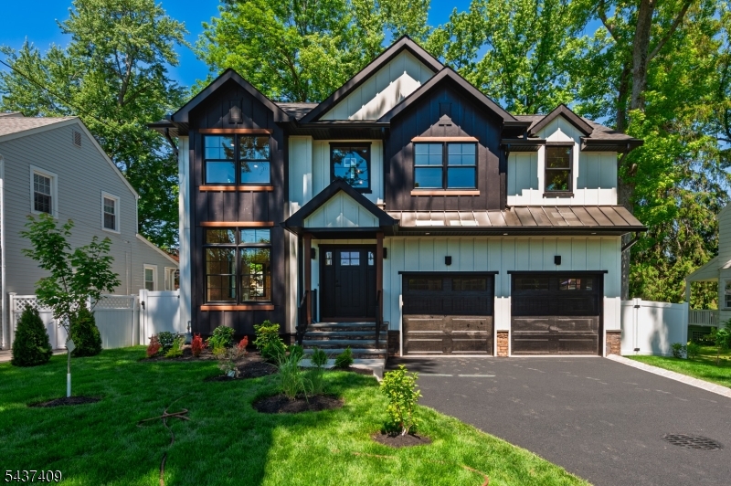 Welcome to this exceptional Custom Modern Design new construction addition nestled in amazing Cranford! Discover this 5-bedroom 4.5 bath home with extensive custom millwork throughout. Quartz countertops, suspended ceilings with custom build in lighting, 5-inch red oak floors throughout. This home features custom-designed oversized windows throughout, enhancing natural light. First level features open concept 9-foot ceilings with center island kitchen and living room with black stainless-steel appliances and quartz waterfall island. Stunning fireplace with build in oak shelves. Dining room built-in wet bar cabinets with a deep sink and beverage cooler. In-law suite/office with private bathroom featuring full walk-in closet and modern fixtures. Mudroom leading to an oversized 2 car garage with high ceilings and more custom shelving. Second floor features oversized primary bedroom with walking closets and en-suite bath that is a true retreat, with high-end tile work and custom lighting. Additional three bedrooms with an suite bath and walking closet. All closets are finished with quality millwork. Oversized laundry with plumbing for two washers. Finished basement for playroom/gym. EV charger ready to be customized for your convenience. This home is a must see for custom blends and timeless quality.