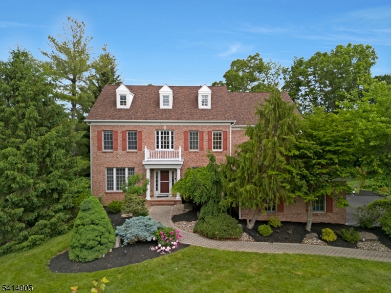 Set on a beautiful property in the highly desirable Top of the World neighborhood, this well-maintained and spacious 5 BR 5 BA home offers a versatile floor plan, generously sized rooms, and exceptional living space throughout. A dramatic 2-story entrance foyer opens to the formal living & dining rooms, creating a warm and elegant first impression. Refinished hardwood floors (2026) extend throughout the 1st floor. The eat-in kitchen with center island breakfast bar flows seamlessly into the main living area, creating an ideal setting for both everyday living and entertaining. Step outside to the deck overlooking the serene backyard with mature trees providing full privacy and perfect for relaxing, hosting, or enjoying the peaceful surroundings. A first-floor bedroom & full bath provide excellent flexibility for guests, multi-generational living, or a private home office. Upstairs, the spacious primary suite features walk-in closet, sitting area & full bath. 3 add'l bedrooms & 2 full bathrooms complete the second level. The full finished walk-out basement with full bath adds exceptional bonus space ideal for recreation, entertaining, fitness, media room, or work-from-home needs. Additional highlights include a NEW roof (2026), functional layout, and convenient access to shopping, dining, parks, and major commuter routes including Routes 22, 78, and 287. A wonderful opportunity to own a spacious, move-in ready home in one of Green Brook's most sought-after neighborhoods.