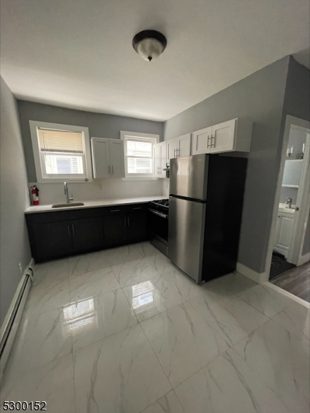 Welcome home to this spacious and well-maintained first-floor apartment, conveniently located on a quiet residential street in East Orange. This inviting unit features a comfortable layout with a bathtub bathroom, a full kitchen, and two bedrooms, offering the perfect blend of comfort and convenience.The property is ideally situated near public transportation, major highways, shopping centers, restaurants, and everyday essentials, making commuting and daily errands simple and efficient.Whether you're looking for a peaceful place to call home or easy access to nearby amenities, this apartment offers the best of both worlds.Available for immediate occupancy. Schedule a viewing today!