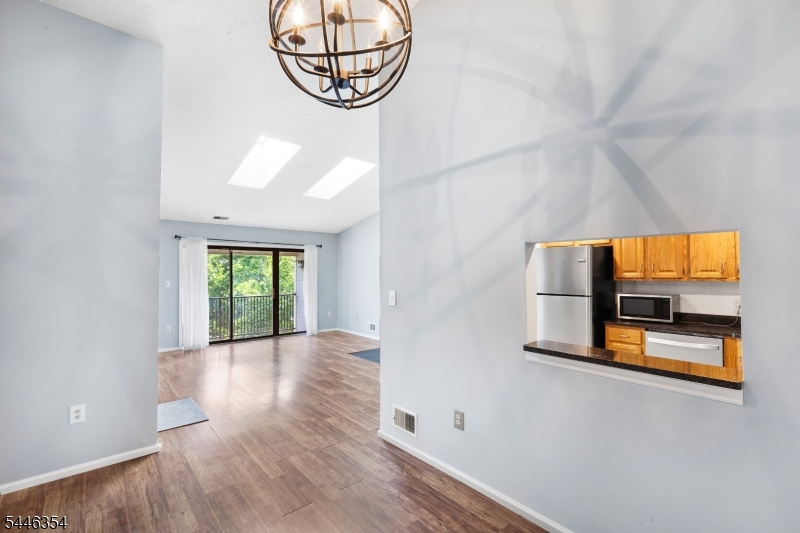 Freshly painted and impeccably maintained, this bright and spacious 2-bedroom, 2-bath penthouse condo is located in the desirable Society Hill community of Basking Ridge. The open-concept layout features a sun-filled living room with cathedral ceilings, new skylights, a two-sided wood-burning fireplace, and extra-wide sliding glass doors opening to private deck. Formal dining room with cathedral ceiling, chandelier, and serving pass through to recently renovated eat-in kitchen with new subway tile backslash, granite counter tops, newer SS refrigerator, new dishwasher and recessed lighting. Recently renovated master bath and main bath ( 2021 ), Newer Central AC, furnace, and hot water heater, laundry/utility room w/ washer and dryer. Well landscaped grounds with walking/ jogging / biking trail, pool, tennis, club house & playground. Great location - commuters delight! Close to Route 78 and NYC train service. Highly rated Blue Ribbon school system.