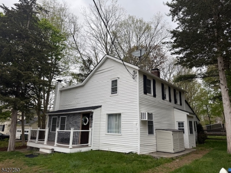 Welcome home to this charming 3 bed 2 full bath Colonial style home. Fully renovated approx 2022. Modern Farmhouse Eat In kitchen w/white shaker cabinets & SS appliances, Laminate flooring throughout, Large living room w/ Wood burning fireplace, Primary bedroom with Full bathroom and spacious closet. Generous sized laundry room, washer and dryer included. Fenced in backyard and shed.  Driveway for 2 or 3 cars. Exterior w/ vinyl siding and roof from approx 2022.  Quaint front porch Treks deck. New septic. Well pump replaced too. Full basement for storage. Upgraded 200 amp electric panel. Just unpack your bags!