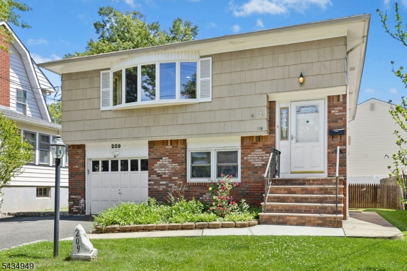 Welcome to this well-maintained split-level home, ready to become your new home. Truly move-in ready, this property offers a fantastic layout across both levels with hardwood floors throughout main level.The main level welcomes you with an open, sun-drenched living room that flows seamlessly into the kitchen, featuring plenty of cabinet space and a separate dining room. Down the hallway, you'll find two well-sized bedrooms, along with a spacious primary bedroom and a shared full bath.The ground level boasts a large family room with sliding doors leading to a patio and private backyard oasis. This level also offers direct garage access into a mudroom, two additional bedrooms, and a generously sized laundry room.Additional updates include a newer heating and cooling system (2023) and water heater (2022). Conveniently located for commuters, the Roselle Park train station is just minutes away, with NJ Transit bus stops within walking distance.