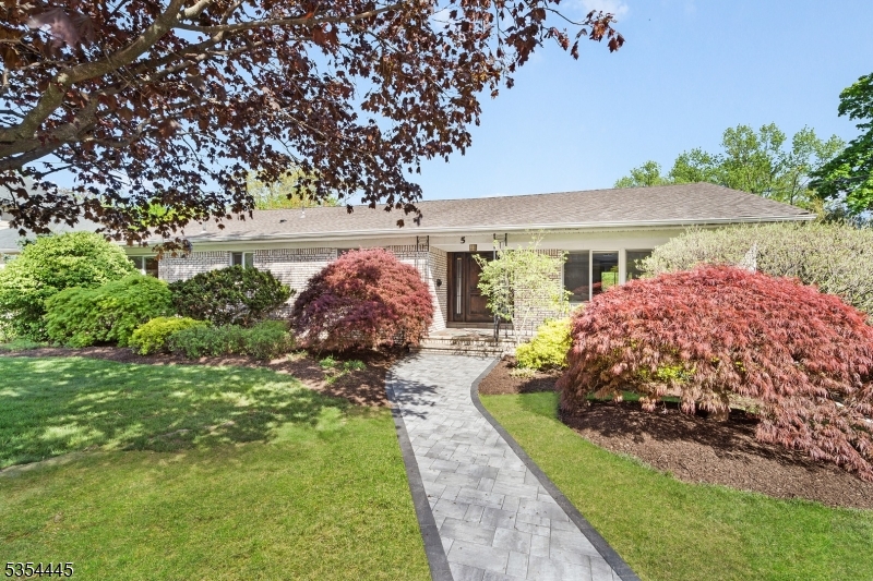 Welcome to 5 Stone Dr, a beautifully updated ranch in the sought-after Oldstead neighborhood. On a park-like lot, this home features a new front walkway, elegant slate porch, & expansive patio blending charm with comfort. Step through the mahogany door into a grand foyer & open layout, ideal for hosting and everyday living. The show-stopping 2023 kitchen BOAsts granite countertops, SS appliances (Viking gas stove), and a spacious center island. It opens to a formal dining room w/ striking stone fireplace, a large family room, and a versatile music room/den. Step onto the deck w/ built-in gas line for effortless grilling and outdoor dining. The main level offers a serene primary suite w/ spa-style shower & jetted tub, a junior suite w/ updated full bath, a 3rd bedroom, and a powder room. DOWNStairs, the walk-out ground level adds 1,100+ sq ft of living space, a generous rec room w/ brick wet bar, and a private in-law suite with its own entrance, kitchen, full bath, & laundry. New Furnace (2024) and Water Heater (2025). Additional highlights include central A/C, attic storage, 2+-car garage, and fenced, beautifully landscaped backyard designed for entertaining & peaceful retreat. Near South Mountain Reservation, Turtle Back Zoo, dining, shopping, NYC transportation, and houses of worship?this home truly has it all. Reassessment will lower property taxes to approx $22,487 in 07/2025, offering significant long-term savings.