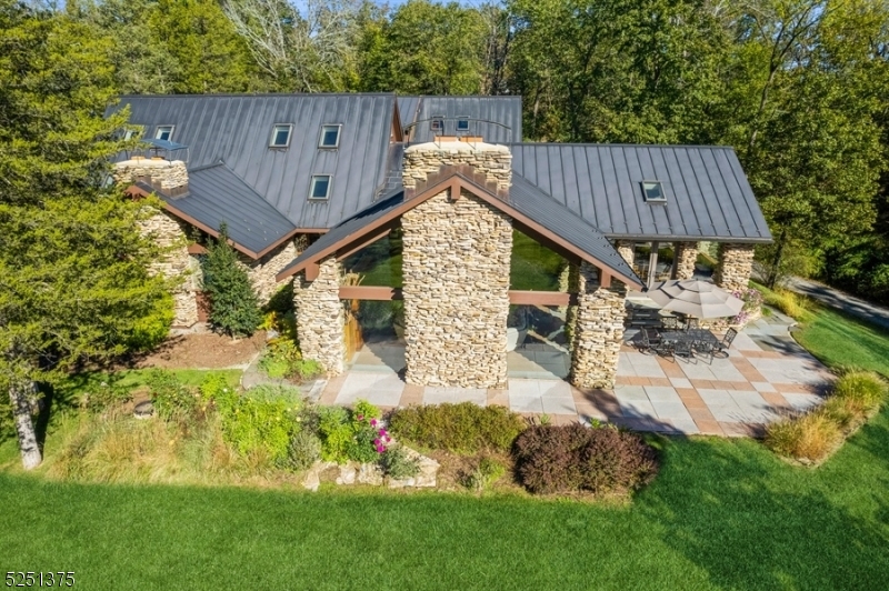 Spectacular 5 BR Custom Home of Distinctive Design, Nestled on Over 5 Beautiful Acres in Bedminster Hunt Country. Open Concept living spaces with Soaring Ceilings, Exposed Beams, Exquisite Wood and Stonework, inside and out. Metal Roof, Newly Remodeled Kitchen (2020) with Quartzite Countertops, SS Appliances and Custom Cabinetry. There are 2 Spacious Primary Bedroom Ensuites, 1 on the 1st Floor and 1 on the 2nd Floor. Both have Luxurious Bath Retreats. 3 additional bedrooms complete the 2nd floor. BR #3 is Ensuite. BR #4 & BR #5 share a Jack and Jill Bath. Mahogany Wood Flooring throughout 2nd floor. Private 1st Floor Office with direct access to an outdoor court yard.  Beautiful planting beds lead to a stone patio overlooking this serene oasis. New LED lighting throughout home (2020). Radiant Heat throughout home. Carlton Inground Pool with Bluestone Terrace. Fabulous Pool House with a Vaulted Beamed Ceiling, Polished Concrete Floors, Kitchen with SS Appliances, Open Concept Living / Dining Space and Full Bath. Easy access to major highways, shopping and transportation. OFFER ACCEPTED