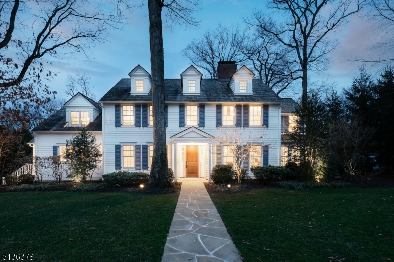 One of Summit's iconic classic center hall colonial. This home has the blend of classic traditional with the modern updates you would want in finishes and floor plan. This home sits on over a half acre of a private wooded lot where you can see the sunset from your pool and outdoor kitchen. The first floor has a dining room, living room, office, large sunroom or den, updated kitchen, mudroom and a family room with high ceilings and oversized windows on all three sides. The second floor has 4 bedrooms, 3 full baths and laundry room. The master suite has a sitting room and updated marble bathroom. The third floor has a bedroom suite and bathroom. In the basement there is bedroom, full bathroom, mudroom and large rec room. The property backs up to the nearly 2,000 acre Watchung Reservation and sits on top of Oak Ridge.