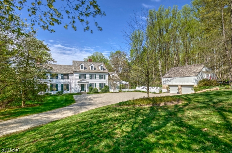 This wonderful 4 bedroom Custom colonial home sits at the end of a long private drive on over 13 plus prime acres of open fields and mature woodlands.  Antique details, beams and stonework.  Views highlight nearly every room-overlooking grounds with flowering perennial gardens, patios, and a heated pool.  An open foyer that leads to the dining room and great room. Country kitchen opens to the family room with a wood burning fireplace and access to the patios and pool. A wonderful study with fine millwork, cabinetry, and fireplace.  The great room has oversized  windows, French doors and a beautiful stone fireplace. A spacious screened in porch off of the kitchen with vintage herringbone brick floor room enough for dining and entertaining and overlooks the property.  The master bedroom suite has a large walk-in closet, three walls of windows, a wonderful masonry gas fireplace, private balcony and large bathroom with radiant floors. Three more bedrooms on this level with wood floors or new carpeting. The walk out lower level includes a great area for an entertainment room, laundry area, large bathroom, workshop, and a unique temperature-controlled wine cellar.  5 Fireplaces, New windows and doors on the Ist level, New cedar shingle roof, updated HVAC, Generator, update electric, new gutters, new exterior painting and farm assessed Acres.