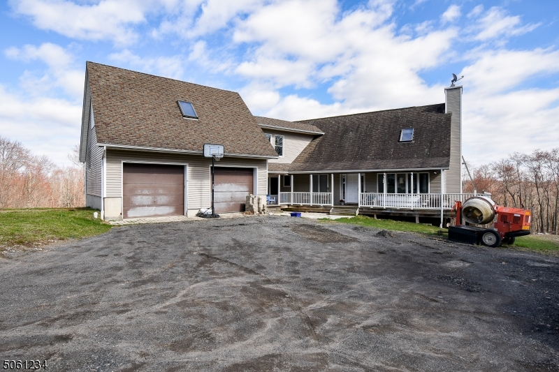 Massive opportunity awaits those with the vision to finish off this spacious custom home set on over 5 acres of private land on a quiet private lane just minutes from Newton and Branchville. Cathedral ceilings, hardwood floors, and bay window in the great room.  3 bedrooms on the first floor including a master bedroom with ensuite bath, vaulted ceilings, loft area and private access to rear deck.  Relax on the covered front porch and entertain while enjoying the mountain views on the massive rear deck.   Full house walkout basement features 10 foot ceilings, framed for a 4th bedroom and plumbed for another full bath.  Breezeway with laundry room leads to huge 2 bay garage and above the garage is space for potential large second master with office.