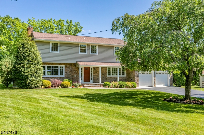 Set on a serene cul-de-sac, this beautifully maintained home showcases years of thoughtful updates and attentive care with contemporary touches, including custom decorative railings and a wooden banister. Stonework on the front and back creates a polished, cohesive look, complemented by two matching sheds and a charming covered front porch. Inside, hardwood floors flow through nearly every room. The main level was renovated for a more open, connected feel, including a completely rebuilt kitchen with walls removed to create an inviting flow into the dining area. Dual sliding doors from both the dining room and kitchen bring in natural light and provide easy access to the patio and saltwater pool. A spacious mudroom with laundry offers direct access to the freshly painted two-car garage and backyard. The family room features a wood burning fireplace and updated recessed lighting, while the flexible front room works beautifully as a home office, playroom, or den. Upstairs, all four bedrooms feature wood flooring and are served by two beautifully renovated bathrooms, including the hall bath and primary suite bath. Since 2012, extensive updates have included major systems, windows, roofing, siding, bathrooms, flooring, and a whole-house standby generator.