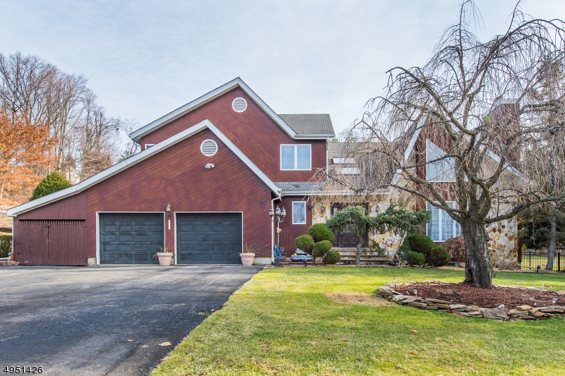Amazing Colonial Contemporary with gorgeous hardwood floors, 3 fireplaces, Master Bedroom Suite w/Fireplace, beautiful outside patio area off kitchen, vaulted ceiling and more! Simply unpack! Beautifully appointed eat-in kitchen with oodles of counter space, formal dining room for entertaining, formal living room with stone fireplace, master bedroom with fireplace, spacious and inviting family room with fireplace [2 wood burning and one gas]. Also boasts 2 car garage, basement for storage, multi-zone hot water baseboard heat and 2 central air units. Move-in ready. Large, level backyard with patio area, ideal for unwinding after a long day. Wayne school systems plus easy access to NJ and NYC transit!