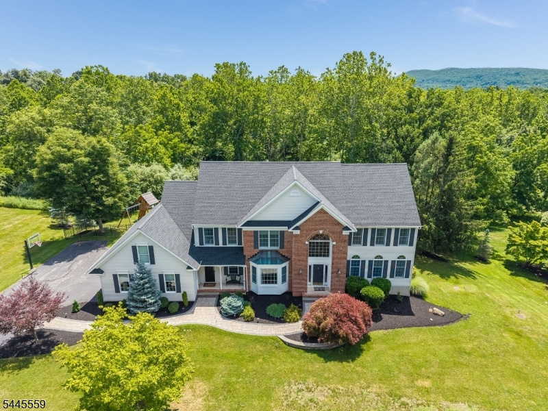 Spectacular, move in condition ,5 br  home w 2nd staircase and serene setting. Top to bottom upgraded custom home. Truly a turnkey home in a great neighborhood and school district. The roof, kitchen, baths, mudroom, landscaping, walkways, patio, fencing have all been replaced by expert craftspeople utilizing top of the line materials. A stunning home with a great floorplan. Home features a recent kitchen w Bosch appliances and soapstone countertops, a large, renovated mudroom w adjoining laundry and a custom pantry. Access to the 3-car garage and 2nd stairway and the 5 th br is thru the mudroom. Home features both a 5 th bedroom and a first-floor office. The MBR features 2 custom designed walk-in closets and a recently completed luxury ensuite bath. All bedrooms are generously sized, and all bathrooms are recently renovated. Outside there's recent landscaping, a new walkway and a new rear patio w built in grill. A recent custom fence w 3 gates was designed for a future pool. The 5-bedroom septic is located in the front yard, and its design was verified w Hunt Cty Board of Health. Home is in the sought-after Clinton Twp Pre-K- 8 th grade and North Hunterdon HS sending Districts.