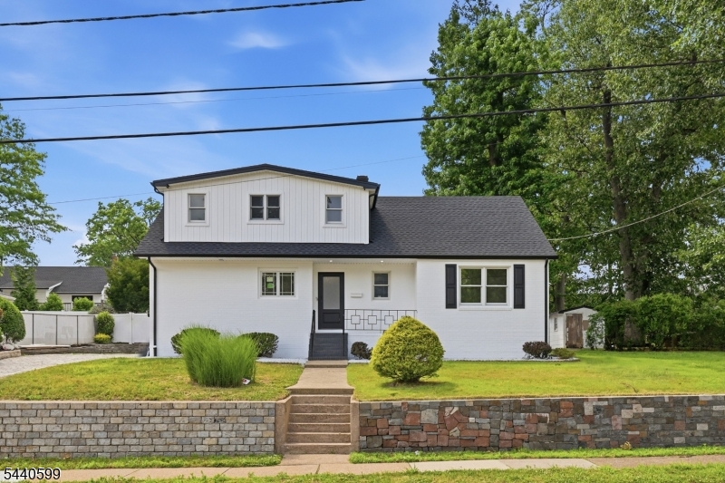 Totally renovated with 2 new kitchens, 2 new full baths, new roof, doors, windows and siding. Hardwood flooring redone, entire house freshly painted; new glass sliders leading to new rear deck. Beautiful lot with mature trees, great outdoor space and large side lot for future expansion. Brick front exterior with front porch. Nice curb appeal with cobblestone driveway and professional landscaping. Located in a fantastic neighborhood with a good school system, public transportation and a short commute to NYC.
