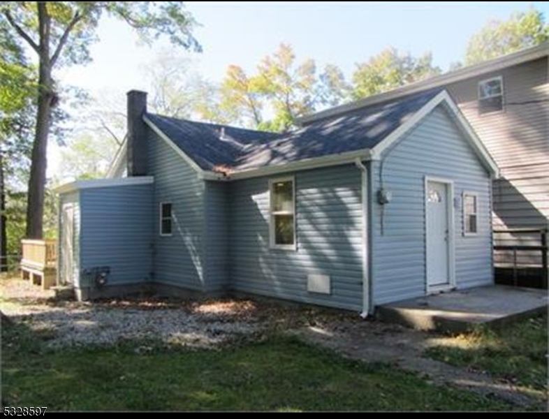 This cozy, 800 sq. ft. house sits nestled along a tranquil riverbank, blending harmoniously with its natural surroundings. It needs love and care. The exterior features a small inviting front porch, perfect for enjoying morning coffee while listening to the gentle flow of the water. Breathtaking views of the river and flood the interior with natural light. Inside, floor plan combines the living, dining, and kitchen areas into a welcoming space with warm, rustic charm.The compact kitchen features appliances The house includes one main bedroom with a peaceful view of the river and a second smaller room that can serve as a guest bedroom or office. Outdoors, backyard offering a serene spot to fish, read, or simply unwind. Surrounded by lush greenery, this riverside retreat is ideal for anyone seeking simplicity and a strong connection to nature. Great opportunity for first time home buyers. AS IS SALE ONLY