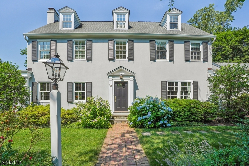 In town perfection!  Step inside this beautifully renovated 5 bedroom colonial to find a fabulous floor plan coupled with current finishes and exceptionally private outdoor living spaces.  Located close to town, train, schools and Memorial Field, this home is one of a kind.  Major renovations beginning in 2013 included moving driveway to Maple and creating circular driveway with parking court, new kitchen/family room, mud room and pantry, dining room with marble entertaining bar, new baths, windows, systems, dug out basement which includes rec room, full bath and 600 bottle wine room.  Incredible private outdoor entertaining and play spaces including multiple patios, professional landscaping, basketball court, level play yard.  Original barn for buyer creative use as well! Generator, sprinkler system, security system, sound system.   Location Location.