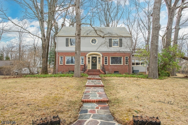 Step into timeless charm with this beautifully preserved 1947 Colonial, where character and warmth meet modern-day living. From the moment you arrive, the home's lush, park-like setting, just under an acre of professionally landscaped grounds with elegant bluestone walkways, sets the tone for something truly special. Inside, you'll find sun-drenched spaces throughout, including a spacious living room featuring high ceilings and abundant natural light, a bright and inviting sunroom, and an oversized kitchen that offers plenty of room to gather, cook, and entertain. Upstairs, two of the four bedrooms open directly to a shared sun deck - an ideal spot for morning coffee or unwinding at the end of the day. The third-floor bonus level adds incredible flexibility, featuring a private office along with a playroom or den, perfect for today's work-from-home or lifestyle needs. Additional highlights include 2.5 baths, stunning bluestone back patio, a detached two-car garage, and thoughtful details throughout that showcase the home's unique character. Located in an unbeatable setting, this property is just a short walk to Brundage Park - home to scenic walking and biking trails as well as the beloved Brundage Park and Brundage Park Playhouse. All of this, plus access to the highly sought-after Randolph school district, makes this home a rare and exceptional opportunity. A one-of-a-kind property offering space, charm, and location this is the home you've been waiting for.