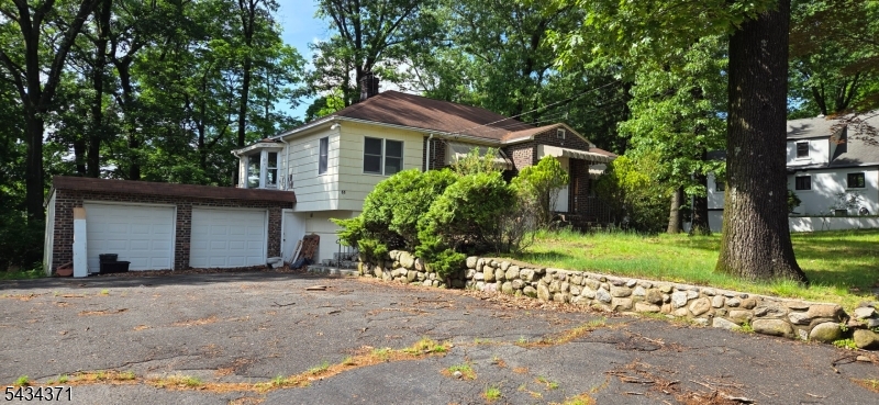 Savvy buyers and investors will immediately see the remarkable potential of this ranch-style home. Situated on a beautiful 1/2 acre lot with mature trees, the property provides endless possibilities for growth and transformation. The home currently offers 2 bedrooms, 2.5 bath, Eat-in-kitchen, living room with stone fireplace, and a partially finished basement featuring a recreational room, utility room, laundry, and designated storage space. While the property is currently served by a well, municipal water is readily available on the street for easy connection. Whether you choose to renovate, restore, expand, or start fresh, the opportunities are limitless! 1st day for showings is May 30th, 2026  HIGHEST AND BEST BY WEDNESDAY 5PM !