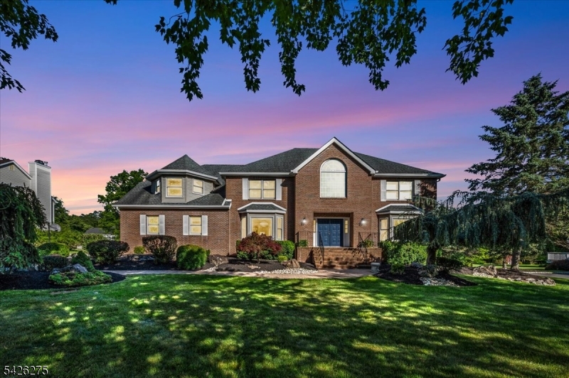 Set on a beautifully landscaped lot, this exceptional 5-bed, 3.1 baths Colonial offers the perfect blend of timeless elegance, generous living space, & modern comfort. A grand 2-story foyer creates an impressive first impression, opening to sun-filled interiors, refined formal living & dining room, & a thoughtfully designed floor plan ideal for both everyday living & sophisticated entertaining. At the heart of the home, the beautifully appointed eat-in kitchen features abundant cabinetry, a center island, stainless steel appliances, & seamless flow to the expansive family room & outdoor living spaces. A 1st floor bedroom with an adjacent full bath provides flexibility for guests or a private home office, while a convenient powder room completes the main level. Upstairs, the luxurious primary suite serves as a private retreat, offering exceptional space, generous closets, & a spa-inspired bath with dual vanities, a soaking tub, & separate shower. 3 additional bedrooms & a full bath complete the 2nd fl. The finished lower level elevates the home's lifestyle appeal with multiple entertainment & recreation spaces, including a private theater room, fitness area, & expansive recreation room designed for gatherings, game nights, & everyday enjoyment. Outdoor living is equally impressive, featuring an expansive deck overlooking a sprawling, flat backyard framed by mature landscaping & picturesque surroundings. Truly remarkable home in a premier neighborhood.