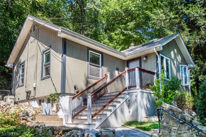 AMAZING Price for Desirable Denville.. Pack your bags and move right in! Charming Ranch style home in desirable Indian Lake. Experience all the amenities of year round lake living! Walk out your front door or sit on the deck or patio for seasonal lake views. Just minutes from the beaches, fishing, boating, swimming, ice-skating or lake access down the street & paddle to all ILCC Clubhouse & Beach Activities*. Welcoming, warm, open interior layout. Completely renovated in 2012. Bright living space w/high ceilings and cozy wood shiplap. Updated kitchen with granite countertops, newer SS appliances & eating area. Gleaming HW floors throughout. Large bedroom & bath with radiant flooring. Lots of room to fit your lifestyle. Pantry/mudroom walkout to deck. Tons of storage in the basement and attic. Super private property surrounded by mature trees, vintage stone walkways, terraces, patio & barbeque backed against acres of preserved woodlands. Partially fenced. Close proximity to NYC direct train, bus & major highways. Walking distance to Downtown Denville! (*lake amenities w/ optional lake membership) Windows, skylights, roof, fence only about 10 years old. Newer split a/c units & front patio.