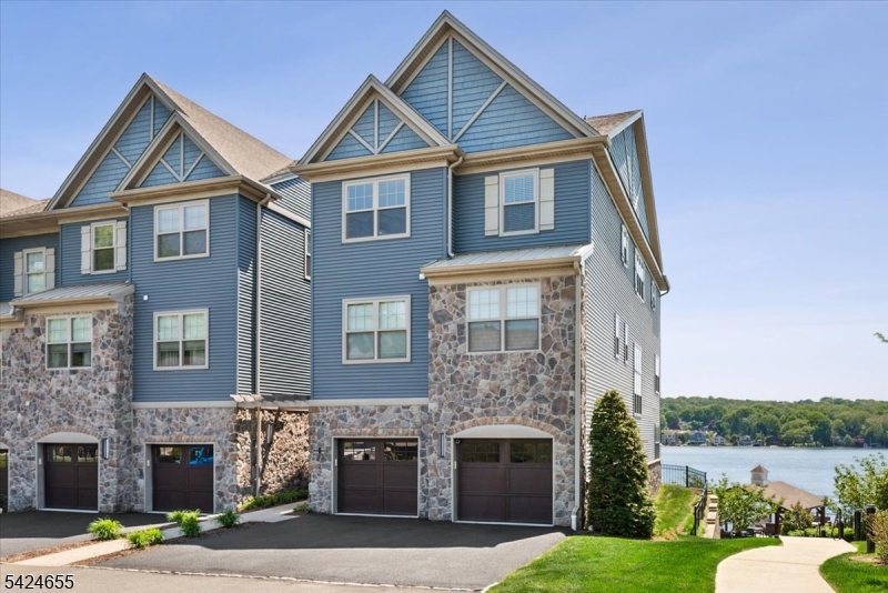 Welcome to effortless luxury on Lake Hopatcong. This 2018 lakefront end-unit townhouse offers 3 bedrooms, 2.5 baths, a loft, 2 balconies, and a private boat slip, all wrapped in modern style and sparkling water views. It is also the largest unit of this type with the loft area. The open kitchen shines with quartz counters, SS appliances, and a generous center island, while new flooring and fresh paint make the home feel brand new. Large primary suite with custom walk-in closet, balcony, double vanity and spacious shower. Spend your days on the water and your evenings on the entertaining deck perched over the lake, complete with grilling stations. Gather around the fire pit while watching the amazing views of New Jersey's largest lake. With public utilities, upstairs laundry, and a 1-car garage, this home delivers comfort, convenience, and the lake lifestyle you've been dreaming of.