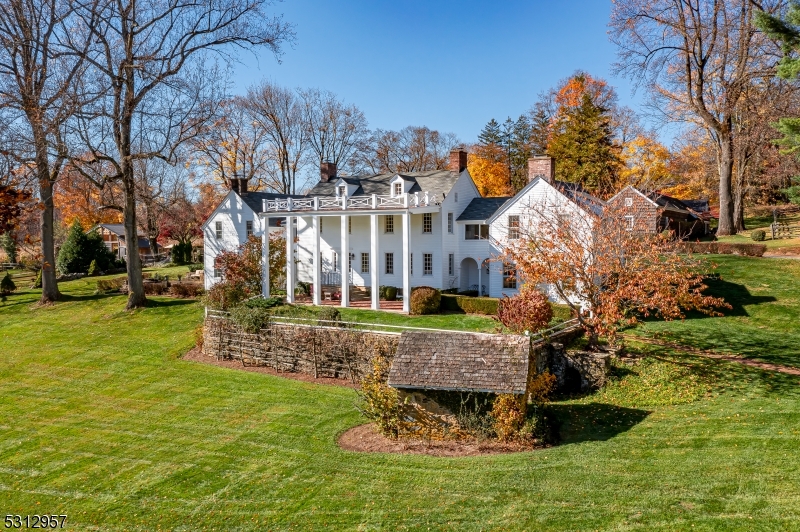 "Black River Farm" - A 52-acre preserved farm located in a bucolic section of Chester Township that is cherished for its country estates and equestrian properties. The land is sublime and surrounded by parkland, ensuring that the tranquility and natural beauty of this farm will remain in perpetuity. A long gravel driveway crosses fenced pastureland and a meandering brook to reach the main residence.  This stately antique Colonial Revival was expanded in the mid-1800's and has been restored and renovated over the past twenty years by the current homeowners. Throughout the home, modern amenities have been thoughtfully blended with many of the original architectural details. The kitchen was expanded to include a large island, ample cabinetry, and a sitting area with a gas fireplace.  A charming two-story cottage features two bedrooms, two full bathrooms, an eat-in kitchen, office and two covered porches.  The cottage is also a legal rental property. Outbuildings and other amenities include an antique (circa 1890) two-story timber frame bank barn used for social events, a pool pavilion with an open lounge that adjoins an outdoor kitchen and spa, a detached three-car garage, an equipment barn with garage space for two more vehicles, a renovated corn crib, a chicken coop, a fieldstone spring house and a heated Gunite pool framed by a level lawn and bluestone patio. Throughout the farm, there are spellbinding views of this incredible setting.