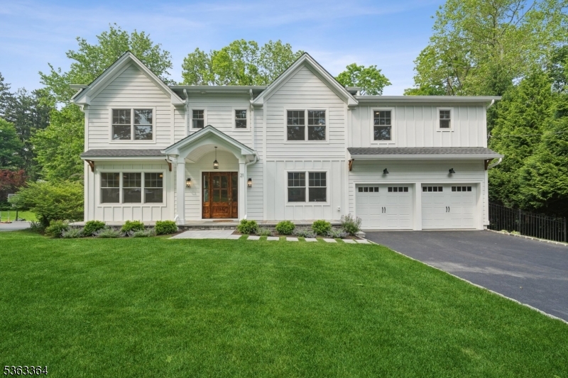 This exquisite 6-bedroom, 5.5-bathroom home is nestled in a cul-de-sac and built by JTS Build & Design on a 0.34-acre lot. It features James Hardie Plank siding, a stone veneer foundation, and Board and Batten accents. Conveniently located just steps from downtown Madison and the train. A 40-year Timberline roof and Andersen windows ensure durability and style. The exterior boasts a bluestone front porch, a Craftsman-style  entry door, elegant paver walkways, and a backyard patio. Inside, extensive millwork, crown molding, designer light fixtures, and 8" white oak flooring add sophistication. The first floor includes a living room, dining room, gourmet kitchen, and family room with a gas fireplace, while the mudroom features shiplap walls, hooks, and a bench. The walk-out lower level offers a bedroom, full bath, rec room, and gym/storage. The second floor has five bedrooms, four full baths, and a laundry room with custom cabinetry. The primary suite boasts a spacious walk-in closet and a spa-like bathroom with a standing shower, soaking tub, and double vanity. The gourmet kitchen features custom shaker cabinetry, a quartz island, and Thermador appliances, including a 48" gas range with a custom hood. Modern conveniences include LED recessed lighting, a two-zone high-efficiency HVAC system, and a 75-gallon water heater. A full landscape package with sprinklers, sod grass, and decorative bushes completes this home. Madison tax assessor has stated that NEW taxes will be $25,300.