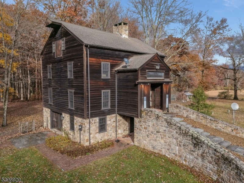 ABSOLUTELY UNIQUE OPPORTUNITY! SET ON OVER 3+ BEAUTIFUL ACRES BACKING TO SERENE PARKLAND & SCENIC WALKING TRAILS, THIS ONE-OF-A-KIND PROPERTY FEATURES TWO DISTINCT HOMES! THE MAIN RESIDENCE IS A STUNNINGLY CONVERTED BARN CIRCA 1880, OFFERING 3 BEDROOMS AND 3 FULL BATHS, BLENDING HISTORIC CHARM WITH MODERN COMFORT. ORIGINAL DETAILS SHINE THROUGH WITH EXPOSED HEWN LOGS, HAND-CRAFTED STONE WALLS, SOARING CATHEDRAL CEILINGS, & SKYLIGHTS THROUGHOUT.THE GROUND LEVEL BOASTS A CUSTOM EAT-IN KITCHEN WITH CENTER ISLAND THAT SEAMLESSLY FLOWS INTO A SPACIOUS RECREATION AREA, COMPLETE W/ A FULL BATH &  WALKOUT ACCESS TO A PRIVATE PATIO.  THE MAIN LEVEL FEATURES A WELCOMING FOYER LEADING TO A DRAMATIC GREAT ROOM WITH WOOD STOVE, FORMAL DINING ROOM, LIBRARY, LAUNDRY ROOM, AND AN ADDITIONAL FULL BATH.UPSTAIRS, THE SECOND LEVEL OFFERS A CHARMING LOFT WITH BEDROOM & FULL BATH, WHILE THE THIRD LEVEL EXPANDS THE LIVING SPACE WITH AN ADDITIONAL LOFT AREA, TWO MORE BEDROOMS, AND A FULL BATH IDEAL FOR FLEXIBLE LIVING ARRANGEMENTS. SECOND HOME IS A FULLY RENOVATED HISTORIC 3 BEDROOM, 3 FULL BATH RESIDENCE CURRENTLY RENTED TO A LONG-TERM TENANT. THIS PROPERTY IS APPROVED BY UNION TOWNSHIP AS A LOW-INCOME (COAH) UNIT AND INCLUDES AN ESTABLISHED WAITING LIST. PLEASE NOTE: THE TENANCY MUST COMPLY WITH COAH REQUIREMENTS AND CANNOT BE CONVERTED TO MARKET RENT. CURRENT RENT IS $2,200 PER MONTH (MAX ALLOWED). SECOND HOME AVAILABLE FOR VIEWING ON A SECOND SHOWING ONLY. 30 MINUTES TO LAMBERTVILLE & NEW HOPE.