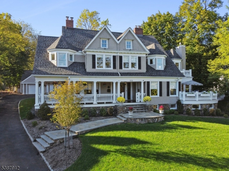 Move right into this warm, inviting home ideal for indoor and outdoor entertaining that blends everyday luxury with unparalleled convenience in the heart of Upper Montclair. Just 2 blocks to the NYC train, top dining, shops, and the Bellevue Theatre, this home offers city-like accessibility with neighborhood charm. Inside, the chef's kitchen is a true showpiece with a Wolf range, SubZero fridge, warming drawers, dual dishwashers, two sinks and a natural gas fireplace. A large center island and access to the gas-connected grill deck make this space perfect for both daily living and entertaining. The 1st floor also features a living room with exquisite millwork and a gas fireplace, a formal dining room with gas fireplace and seating for 12, a rotunda-style family room, and a powder room and mudroom for everyday ease. Upstairs, the luxurious primary suite awaits with an attached private office, marble bath and large walk-in closet. Four bedrooms - two with en suite baths - a hall bath, and luxe laundry rm complete the 2nd floor. The 3rd floor includes two more bedrooms, a full bath, and a bonus room. Versatile basement includes wine room, gym, hobby room, family room, a custom sensory gym (with home theater potential), and powder room. Enjoy the outdoors: mahogany wrap-around porch is perfect for relaxing, dine al fresco on the kitchen deck, roast s'mores on the bluestone patio. Invisible fence. 3-car garage with full 2nd fl ready for finishing. A true gem!