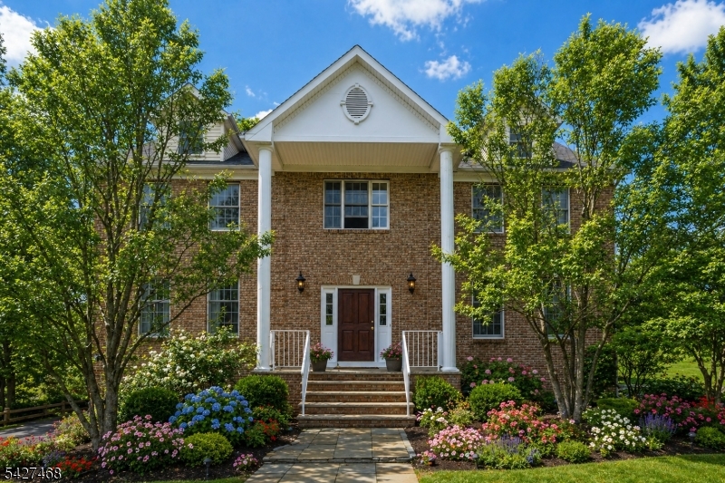 Welcome to a stately, classic Colonial set on a private, park-like setting near Union Hill Farms. Nestled on nearly 2 acres of property & backing to 8 acres of protected, town owned wooded land, this home offers exceptional privacy, serene surroundings & timeless curb appeal. A sweeping approach from Cooper Rd/Druid Hill which allows for privacy, leads to this impressive 4 BDRM, 3.5 bath residence offering over 5,600 sqft of living space. Built by the original Cedar Gate contractor, the home showcases quality craftsmanship & a commanding presence. A grand 2 story foyer sets the tone, opening to a bright, open concept layout ideal for both everyday living & upscale entertaining. The gourmet chef's kitchen features a large center island, butler's pantry with sink & sunlit breakfast area, seamlessly flowing into the expansive family room. Additional standout spaces include a sun drenched conservatory, perfect for a billiards room or lounge & a private 2nd floor office. The luxurious primary is a true retreat, complete with an oversized sitting room with fireplace & a spa-like ensuite bath. Step outside to the expansive deck, ideal for entertaining or enjoying peaceful sunrises & sunsets surrounded by nature. Full basement with endless potential, attached 3 car garage & close proximity to DWTN Denville, Union Square shopping, Morristown Green & NYC direct train access. This one-of-a-kind luxury home offers the perfect blend of privacy & convenience in the heart of Morris County.