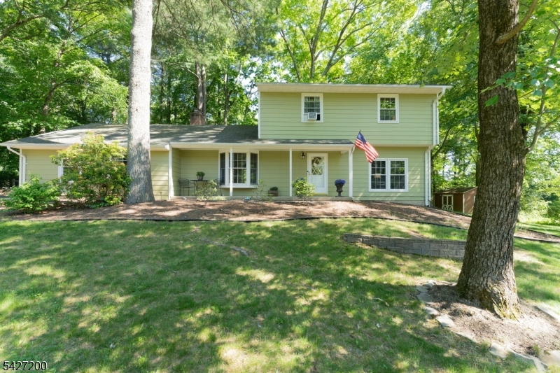 Set on a beautiful lot in an established Clinton Township neighborhood is this delightful 3 bedroom, 2 1/2 bath Colonial Home. You will love that all 1st floor living spaces have large windows or sliders and views of the beautiful back yard and shade trees. The sunken living room is generously sized with windows to the front and sliders to the back that leads out to the deck that spans almost the entire length of the house. Large dining room flows into a cozy family room with a wood burning fireplace just off the kitchen. Kitchen features granite counters and stainless-steel appliances. Multi tiered deck is great for entertaining or enjoying the privacy & natural setting. Laundry, 1/2 bath & oversized garage make up the remainder of the 1st floor. The 2nd floor features large primary bedroom w/ walk in closet & full bath. Bedrooms 2 & 3 share the main bath. In this home you will find hard wood floors throughout except in family room, kitchen & bathrooms. Basement has a workshop & there is plenty of space to convert to a rec room, gym or storage. Home has public water & natural gas. Offered with a Home Warranty. This property backs to Echo Hill Park & offers many other places to explore including Round Valley Reservoir in close proximity. It's a quick drive to Clinton or Flemington where you'll find great shopping & restaurants.  Top rated schools of Clinton Township & North Hunterdon HS. Commuting routes are close by. You will love living here!