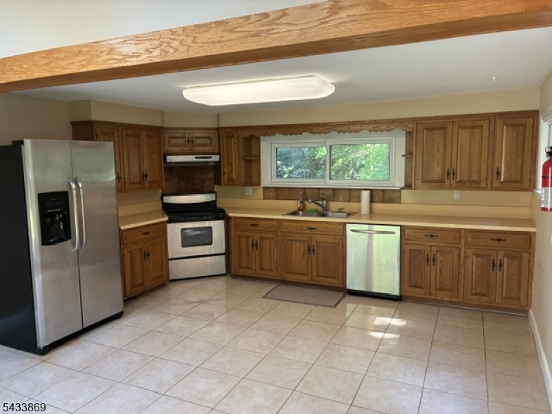 Rare opportunity to own this 3 bedroom, 2 full bath home which sits on 1.19 acres of park-like land. All spacious rooms! The opportunities are endlessand plenty of room for expansion. This home offers ample Natural Light from the many featured Skylights, Large EIK/Dining Area, SS kitchenappliances & sliders to spacious yard, 2 Full Bath/ each w/ double sinks. Warm & inviting LR w/ 4 skylights. Master bedroom w/ master bath. Walk-outbasement could be used as family room or office. Plenty of storage throughout the home! Non-flood area. Conveniently located to shopping, Majorroadways & NJ Transit center. Perfect for commuters. NJ Transit Bus stop is only 2 blocks away. Lots of Privacy on an extra-large level lot located on aquiet dead end street. Top Rated School system. Make this your first stop! AGENTS BRING YOUR BUILDERS!