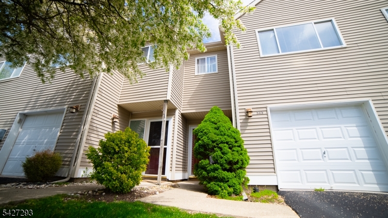 Welcome to this rarely available 2-bedroom, 2.5-bath townhome in the desirable Falcon Ridge community, perfectly situated just off Route 23 for an easy commute. This home stands out with a sought-after one-car garage, a feature not commonly found in many nearby units. The layout offers both comfort and functionality, starting with a welcoming mudroom entry that provides direct access to the garage and an unfinished basement, ideal for storage and laundry. Upstairs, the main living level features an open-concept design with a bright kitchen, complete with a breakfast bar, flowing seamlessly into a spacious living room highlighted by soaring ceilings and a gas fireplace. The primary bedroom is also located on this level and offers a private retreat with a walk-in closet, full en-suite bath, and access to a deck surrounded by flowering trees. The upper level includes a generously sized second bedroom with its own full bath, providing privacy and flexibility for guests or a home office. Falcon Ridge is a well-kept, small community offering amenities such as a pool, along with the convenience of trash and snow removal included in the HOA dues. Don?t miss this opportunity to own a hard-to-find unit in a prime location!