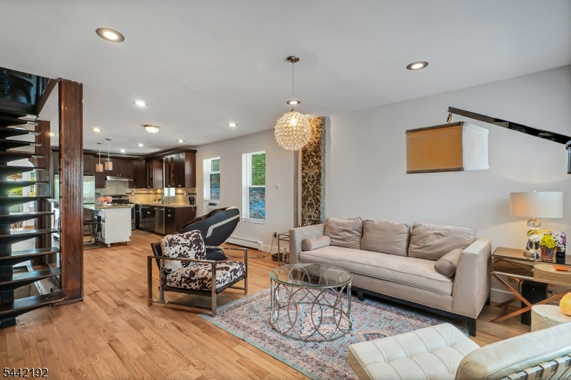 Sophisticated design and modern elegance come together in this beautifully renovated corner home featuring 3 spacious bedrooms and 2.5 bathrooms. Designed with an open-concept layout and seamless flow, this move-in-ready residence offers the perfect blend of style and functionality.The main living area is highlighted by stunning exposed brick accents and a dramatic floating staircase with glass railings, creating a distinctive architectural centerpiece and a contemporary loft-inspired feel. Beautiful hardwood floors flow throughout the home, adding warmth and character.The chef's kitchen is thoughtfully designed with rich custom wood cabinetry, granite countertops, a center island with additional seating, stainless steel appliances, and a decorative tile backsplash, making it ideal for both everyday living and entertaining.The home also features a full basement, providing endless possibilities for additional living, recreational, or storage space. Enjoy outdoor living with a private backyard and a private balcony off one of the bedrooms, creating the perfect retreat to relax and unwind.Completely renovated and meticulously maintained, this exceptional property combines modern finishes with timeless design. Conveniently located near major highways, public transportation, shopping, restaurants, parks, and everyday conveniences, this home offers the perfect balance of comfort, style, and accessibility.