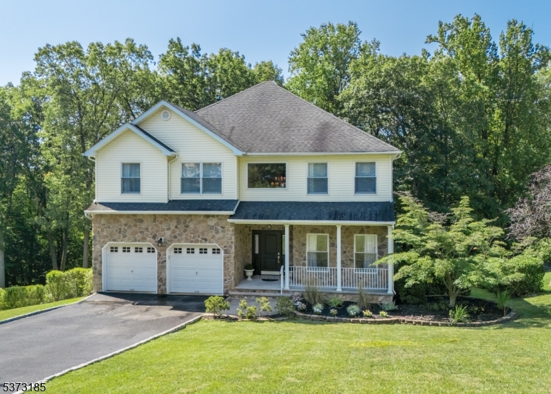 BEAUTIFUL, NORTH-FACING 4 BEDROOM MORRIS PLAINS COLONIAL ON QUIET CUL-DE-SAC IN COVETED GLENMONT COMMONS NEIGHBORHOOD! Amazing location nestled between walking trails, courts, playgrounds in tranquil Mountain Way/Central Parks & minutes from shops/restaurants/4 highways (287/80/280/10). Instantly impresses with fieldstone/siding exterior, manicured planting beds & welcoming covered front porch. Bright, sunny Entry Foyer opens to smart floorplan boasting Office/Bedroom & Laundry/Mudroom on First Level. Sparkling hardwood floors throughout (installed 2024 on Second Level). Spacious 2-story Family Room wows with tall stacks of windows, slate-surround woodburning fireplace. Chef's Kitchen sized for a crowd has distressed wood Center Island w/seating on 2 sides, s/s appliances, granite countertops, large Pantry. Glass French doors open to spacious wood Deck w/ Gazebo ideal for outdoor entertaining or morning coffee. Upstairs 3 spacious bedrooms with double-door Closets share Full Hall Bath w/ white wood double vanity and granite countertops. Primary Bedroom has 2 large Walk-In Closets (1 with custom built-ins), windows overlooking Front yard. Sprawling Lower Level offers several finished rooms for playing, relaxing, or exercising, and potential to finish Workshop for even more space. Sliding glass doors for walk-out access to fully fenced, lush, tree-lined Backyard w/ new shed. Fresh paint, generator hookup & many other upgrades. Excellent schools. Don't miss 63 Gathering Hill!