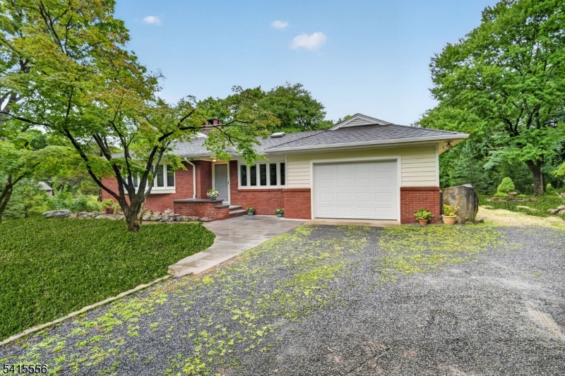 This inviting 4 bedroom, expanded ranch with an open kitchen in the heart of the home is set on 3 park-like acres close to highly regarded Montgomery Schools, library, playground, shopping & restaurants! The kitchen takes center stage! Chef's will delight in the 48  6 burner range with a griddle, double oven & exhaust hood, all SS appliances, granite counters, island, pantry, expanded open eating area with skylights, bar sink & add'l cabinets plus a sunroom adding light & outdoor views. The living room features a beamed ceiling, fireplace with built-ins plus a large window & the dining room also boasts built-in storage with a nod to mid century design. The 4th bedroom is privately in the front of the house while the primary bedroom with its own bath, 2 more bedrooms & the updated main bath are in the back of the home. All with views of the backyard. The large paver patio & outdoor kitchen are ready for dining. The finished basement provides a comfortable space for entertaining, play or work. As a bonus for car enthusiasts, wood workers or hobbyists is an oversized 2 car detached garage (plus a 1 car attached garage) with a workshop & 2nd floor loft for storage. Don't miss out on one floor living with the bonuses of a gourmet expanded kitchen, finished basement & detached garage/workshop. Peace of mind comes from a boiler (2025), water heater (2026) & septic (2026). Your property is private, but so conveniently located. A new Whole Foods, Ulta & more are opening this year.