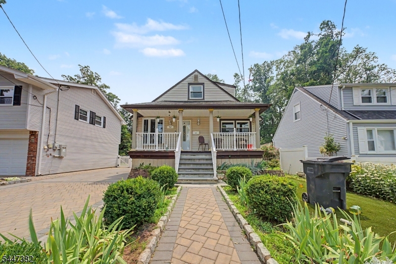 A rare find in Bergenfield. Welcome to 92 Blauvelt Ave, a custom Cape set on an oversized double lot offering space, flexibility and possibilities that are hard to find. Relax on the lemonade porch before stepping inside to gleaming tile and hardwood floors, a living room, dining room and modern kitchen with stainless steel appliances. The main level primary bedroom features cathedral ceilings, a private bath with skylight and access to a balcony. Upstairs offers two additional bedrooms and a half bath. The fully finished basement adds even more space with a bedroom or entertainment room, utility and storage areas, room for a gym and an additional bonus room with sliders opening to the oversized property. A large detached one car garage, expansive parking area and bonus office or storage space above complete this unique property. Enjoy the convenience, shopping, dining and NYC transportation that continue to make Bergenfield a popular place to call home.
