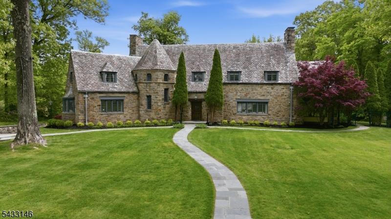 Set on over an acre of exquisitely landscaped grounds, this extraordinary European-inspired estate seamlessly blends old-world charm with today's finest modern luxuries all while just door to door in 44 to Penn Station! Over the past 20 years, the owner has invested in custom high-end renovations carefully designed to preserve the timeless character of the home while modernizing its infrastructure and amenities. Resembling a storybook castle from the outside, the residence features extensive improvements including electric, plumbing, boiler systems, slate roof, and custom masonry work. Inside, grand-scale living spaces are highlighted by remarkable craftsmanship, elegant architectural details, and exceptional natural light throughout. The centerpiece of the home is the stunning chef's kitchen boasting a thoughtfully designed space, complete with a massive center island, premium appliances, handcrafted cabinetry, and seamless flow for both everyday living and entertaining. Additional first-floor spaces include formal living and dining rooms, a library/office, family room, and a breathtaking all-glass atrium. The resort-like grounds are equally impressive, featuring tiered patios, expansive lawn space, pool area, and a guest house complete with its own kitchen, bedroom, and full en-suite bath ideal for guests, extended living, or private entertaining. Essex Fells elementary is the #2 ranked public elementary school in NJ. Just a few streets away from Essex Fells Country Club!
