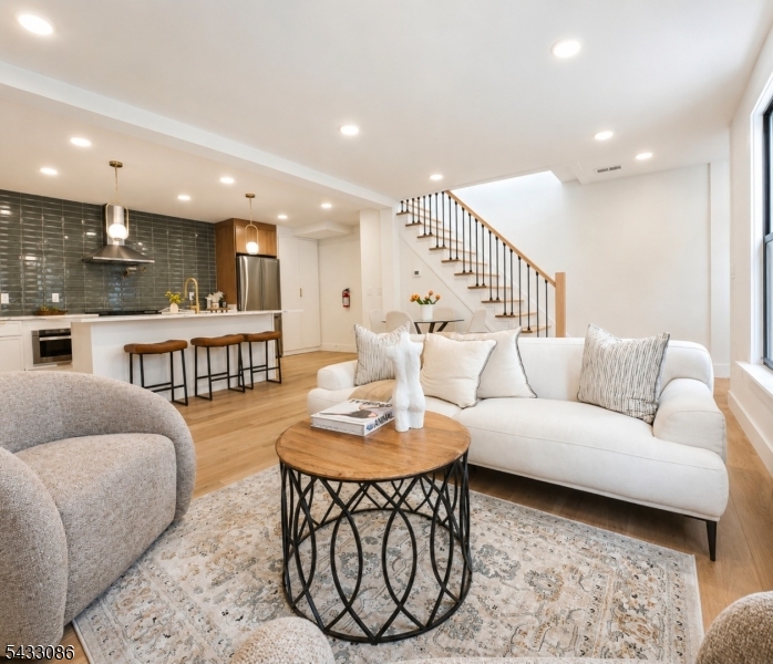 Rare opportunity to own a true single-family home in the highly sought-after Jersey City Heights no condo fees, just modern luxury, privacy, and incredible curb appeal. This bright and sunny home features 3 bedrooms and 3 full ensuite bathrooms, including a first-floor bedroom perfect for guests or flexible living. Step inside to an open-concept layout showcasing oversized 8-foot doors, skylights, designer finishes, and abundant natural light throughout. The stunning chef-inspired kitchen flows seamlessly into the living and dining areas, creating the perfect space for entertaining and everyday living. Enjoy a finished basement ideal for additional living space, gym, office, or media room, along with a private deck directly off the bedroom for your own peaceful retreat. Located in a prime Jersey City Heights community near parks, shopping, restaurants, Light Rail, PATH, buses, and direct NYC transportation a true commuter's dream.
