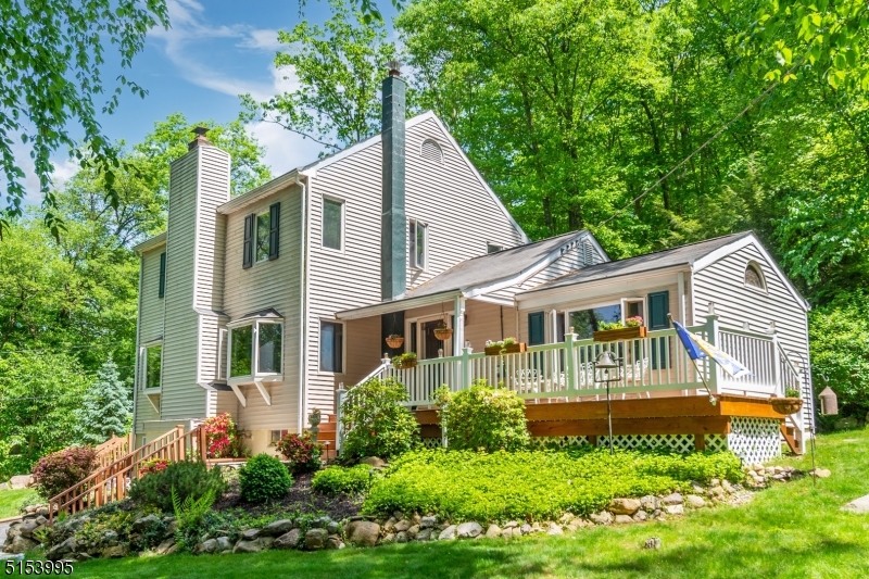 An oasis of peace, privacy & personality! Charming Colonial situated on a quiet Cul-De-Sac in Great Neighborhood backed against Jonathan's Woods which includes 635 protected green acres. Enjoy bright, spacious living w/the privacy of nature. This unique property offers a functional layout. Lots of Generous Room Sizes to Spread Out & Make Your Own! Beautiful HW Floors. BRIGHT living space; HUGE LR/DR Combo. Brick faced fireplace w/Wood burning Timberline stove. Functional, Galley Kitchen w/Solid wood cabinetry & eating area. Gorgeous family room which boasts cedar shiplap, cathedral ceiling, beams, industrial fixtures & stained glass. A room you'll want to spend your time in! 1st floor bdrm & full bath. Upstairs, 2 bdrms & bath including master suite w/jacknjill access to bath & walk-in closet. Supersized bsmt offers finished space & powder room. Laundry, workshop & plenty of storage - plus 1 Car Garage, Walk up attic & 2 storage sheds. Great outdoor space.. Backyard is large, wooded and private. Perfect spot to enjoy nature, mature trees/perennials, lawn, landscape & garden- relaxing! Choose to spend your summer evenings on the back deck or front deck. Trust me, you can't go wrong. Located just steps from walking/hiking trails. Easy access to Downtown Denville, NYC Direct train/bus & major hwys. Denville living at its best!