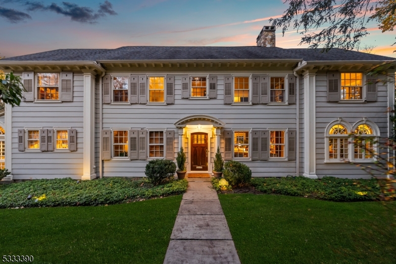 Welcome to Altamont, a unique residence atop First Mountain on Montclair's prestigious Lloyd Road, blending town and country living. This stately Palladian home offers breathtaking views of the Manhattan skyline, with sunrises and sunsets over Eagle Rock Reservation's 500 acres of trails. Built in 1919, it combines timeless craftsmanship with modern updates. Antique glass windows bathe the home in natural light, framing stunning views of Montclair and Manhattan. Generous rooms with soaring ceilings, elegant moldings, and 3 fireplaces create an inviting atmosphere. The custom kitchen features hand-cerused white oak cabinets, hidden storage, oak dovetail construction, and limestone quartz countertops. Expansive windows in the breakfast area offer uninterrupted views of Manhattan. The Sun Room w/Palladian windows is not to be missed. Upstairs, the primary suite w/gas fireplace, dual-facing windows, and sunroom/office. 5 additional bedrooms offer spectacular NYC skyline views. Fr doors open to an expansive deck cantilevered over gardens. The full-floor walkout garden level has 10-foot ceilings, flexible spaces, + panoramic skyline views. Modern amenities include steam heat, zoned central air, + integrated music system. Just minutes from Montclair's dining, boutiques, and cultural attractions, Altamont offers a private sanctuary with terraced gardens and mature landscaping, and convenient access to major highways, Newark Airport, and NYC.