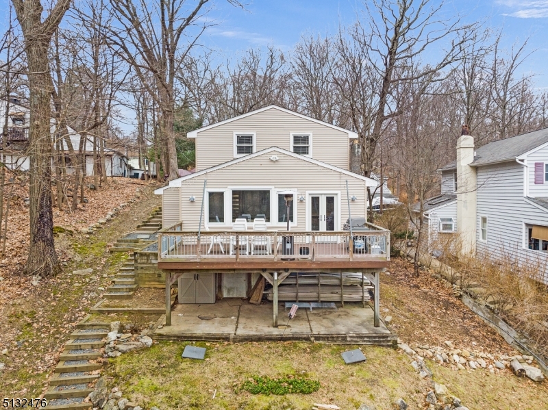 Welcome to the Lake! SECOND CHANCE! h  This Fully Renovated Custom Home 2 bed 1 bathroom on Lake Hopatcong is BACK ON MARKET ! Kitchen is updated with a beautiful quartz & stainless countertops, stainless steel appliances, farmhouse porcelain sink, and subway tile backsplash. Eat at the refurbished bowling alley breakfast bar while taking in a view of the lake.  Walk out double doors from kitchen onto deck perfect for entertaining. Beautiful engineered hardwood & open layout throughout kitchen, living room, dining room and laundry closet. One spacious bedroom on main floor. Fully renovated bathroom with rain shower head & beautiful tile finishes out the first floor. Take the spiral staircase up to oversize master with sitting area & built ins cabinets & amazing walk in closet for storage. Reclaimed wood floor spans the second level. Windows allow for abundance of natural light & view to admire the lake.  Lots of storage space in basement & shed. Enjoy the fire pit, docks, and all that lake life has to offer. Well & Septic Passed inspection! 30 day close in time for summer at the lake! Move right in!