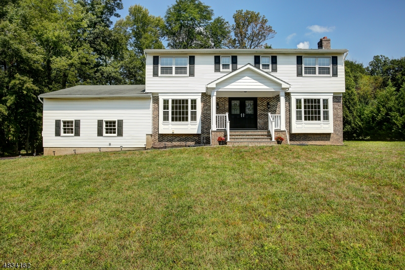 Walk into a bright,freshly painted inside and out, largest colonial model in Brittany Park, with the 5th bedroom on the first level. New tile foyer and kitchen floor, Granite counters and stainless appliances are just apart of this remodeled kitchen. Refinished hardwood floors,New a/c unit and air handler, gas heat, new gutters on front of house and back porch, New front door and siding on front of home, new extended front porch and walkway, repaved driveway, are just a few amenities this home has to offer. 2 New baths and remodeled Master plus walk in closets and dressing area. Spacious rooms throughout. Brick fireplace, sliding glass doors to enclosed porch looking onto large flat back yard!Extra large full basement with high ceilings!